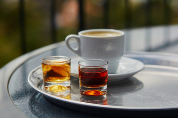 Two glasses of Madeira wine and cup of fresh espresso coffee
