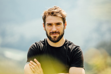 portrait of a man with beard in the mountains