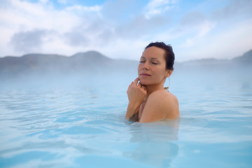 Woman enjoys spa in geothermal hot spring