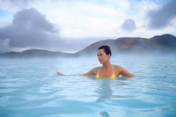 Woman enjoys spa in geothermal hot spring