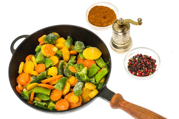 Frozen vegetables in cast-iron frying pan