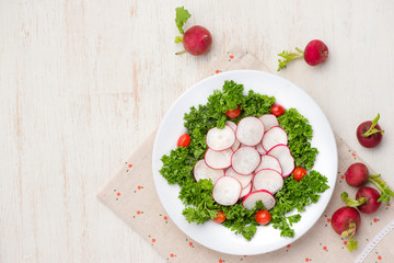 Homemade fresh radishes vegetable salad on table. Close-up.