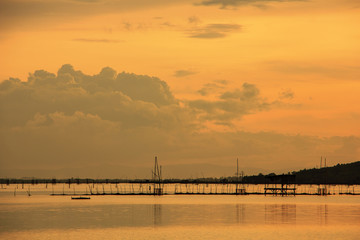 Fototapeta na wymiar View of Songkhla lake which has fish cage in water at sunset ; Koh Yor, Sonkhla province, Thailand 