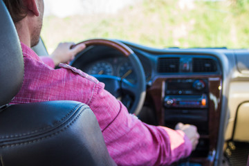 Man driving a car. Hands on the transmission