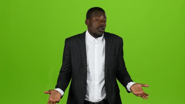 African american is indignant, he is angry and aggressive. Green screen. Slow motion