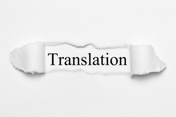 Fototapeta premium Translation on white torn paper