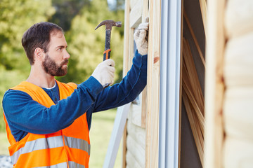 Handwerker bei Hausbau mit Hammer