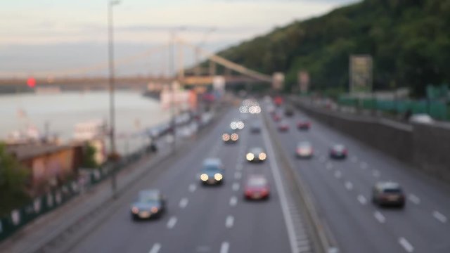Road, cars, blurred background, bokeh. Out of focus cars on the street