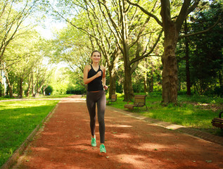 Young woman exercising running in summer park