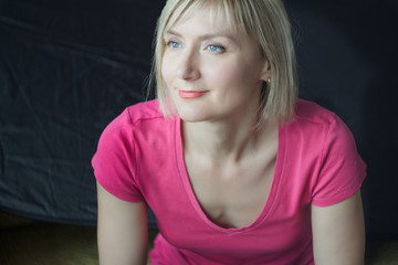 Studio headshot portrait of mature woman wearing fuchsia shirt