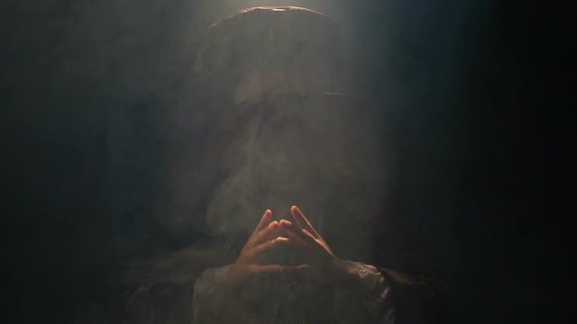 The Hatter looks out of the smoke