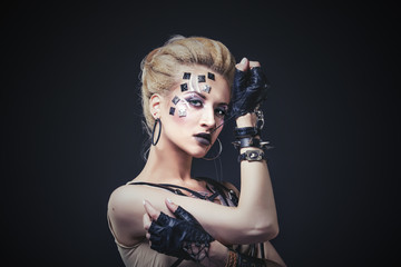 Woman beautiful model with body art of unusual and fashionable clothing in the Studio