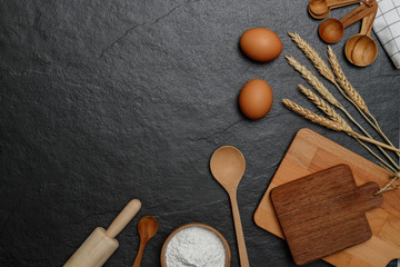 Top view kitchen utensils and baking ingredients mockup on dark border background  with notebook...