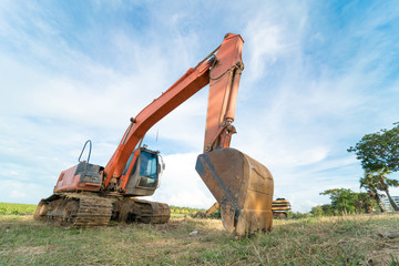 Close-up of a construction site excavator with blue sky