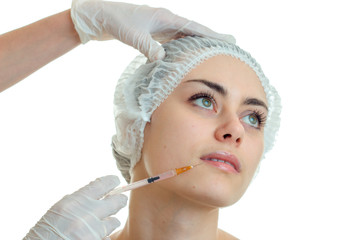 close-up portrait of a young cute girls hair in the CAP which holds facial procedures esthetician