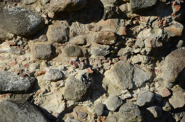 Old weather beaten stone wall of a ruin.