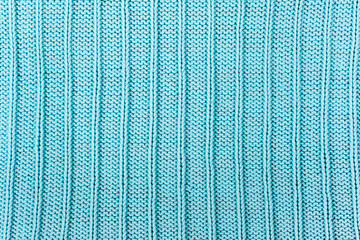 Sweater or scarf fabric texture large knitting. Knitted jersey background with a relief pattern. Wool hand- machine, handmade.
