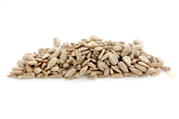 Natural shelled sunflower seeds on white background