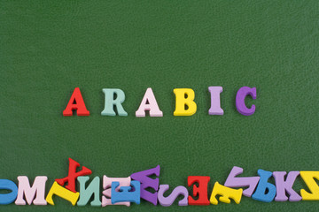 ARABIC word on green background composed from colorful abc alphabet block wooden letters, copy space for ad text. Learning english concept.