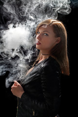 Beautiful girl vaping from e-cigarette.