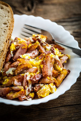 Pieces of sausage fried with egg.