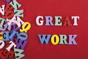 GREAT WORK word on red background composed from colorful abc alphabet block wooden letters, copy...
