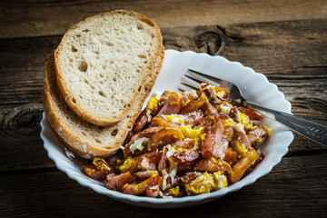 Pieces of sausage fried with egg.