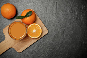 Fresh orange juice in glass dark stone background. Copy space for text