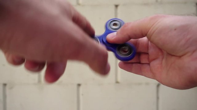 Playing with Blue Fidget Spinner