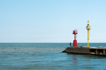 Fototapeta na wymiar Lighthouse and entrance to the port of Cesenatico. Rivera Romagnola