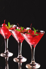Strawberry daiquiri cocktail with lime, strawberry, cherry and mint