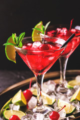 Strawberry daiquiri cocktail with lime, strawberry, cherry and mint