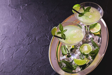 Classic daiquiri cocktail with lime, ice and mint