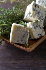 Blue cheese on a wooden table .