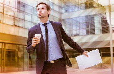 man with documents hurrying to meeting