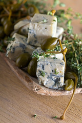 Blue cheese , capers and branches of thyme.