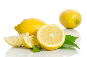 Two lemons and half with leaves  isolated on white background