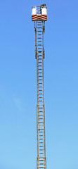 Basket with aerial platform over the very long special ladder of
