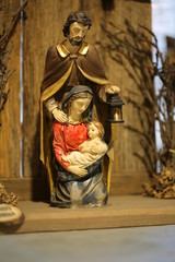 nativity set with the Holy Family and Saint joseph who holds a l