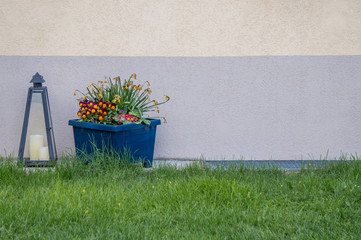 Candle and flower pot on the exterior of a building