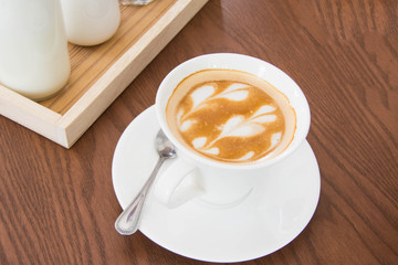above view of coffee latte art on wooden table.