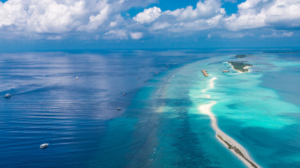 Naklejka na ściany i meble Maldives beach from birds eye view. Aerial view on Maldives island, Ari atoll. Tropical islands and atolls in Maldives from aerial view. Summer holiday beach landscape background in Maldives.