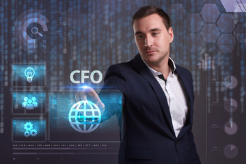 The concept of business, technology, the Internet and the network. A young entrepreneur working on a virtual screen of the future and sees the inscription: CFO
