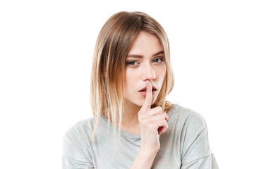 Naklejka premium Amazing serious lady showing silence gesture