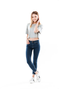 Full Length Portrait Of A Smiling Young Girl