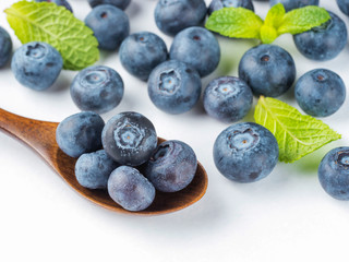 Blueberries in spoon on dark background