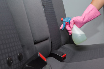 Chemical spray on the car interior textile seats. Early spring cleaning or regular clean up. Professionally chemical cleaning.