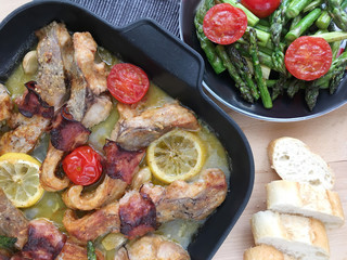 Fillets of carp roasted with bacon, garlic and lemon. Served with grilled vegetables - asparagus and tomatoes.