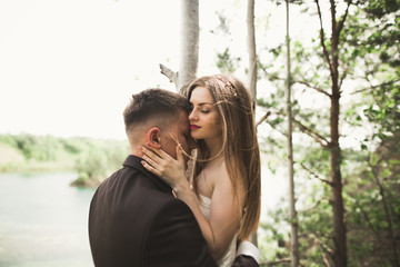 Kissing wedding couple in spring nature close-up portrait
