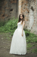 Gorgeous romantic gentle stylish beautiful caucasian bride on the background ancient baroque castle